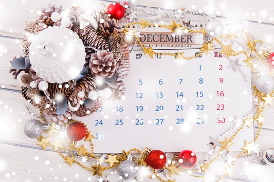 Calendar marked for December surrounded by Christmas decorations for the ultimate guide to Christmas party planning party 2