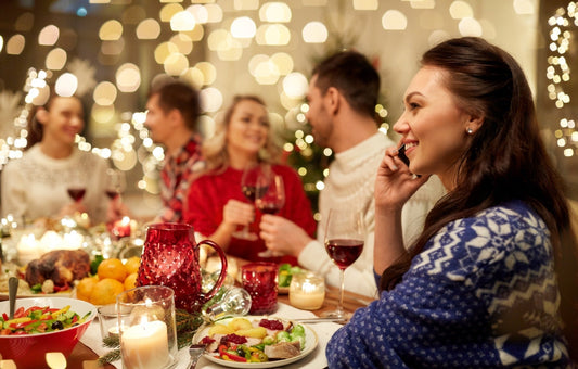 Friends enjoying a festive Christmas party with food and drinks in the ultimate guide to Christmas party planning part 1