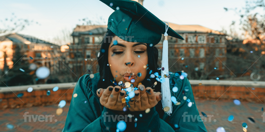 Graduation celebration with graduate in cap and gown blowing blue and white confetti representing personalized graduation party trends for 2024