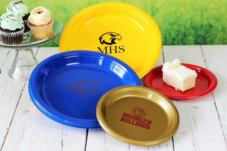 Personalized graduation party plates in yellow, blue, red, and gold with custom school logos and mascots