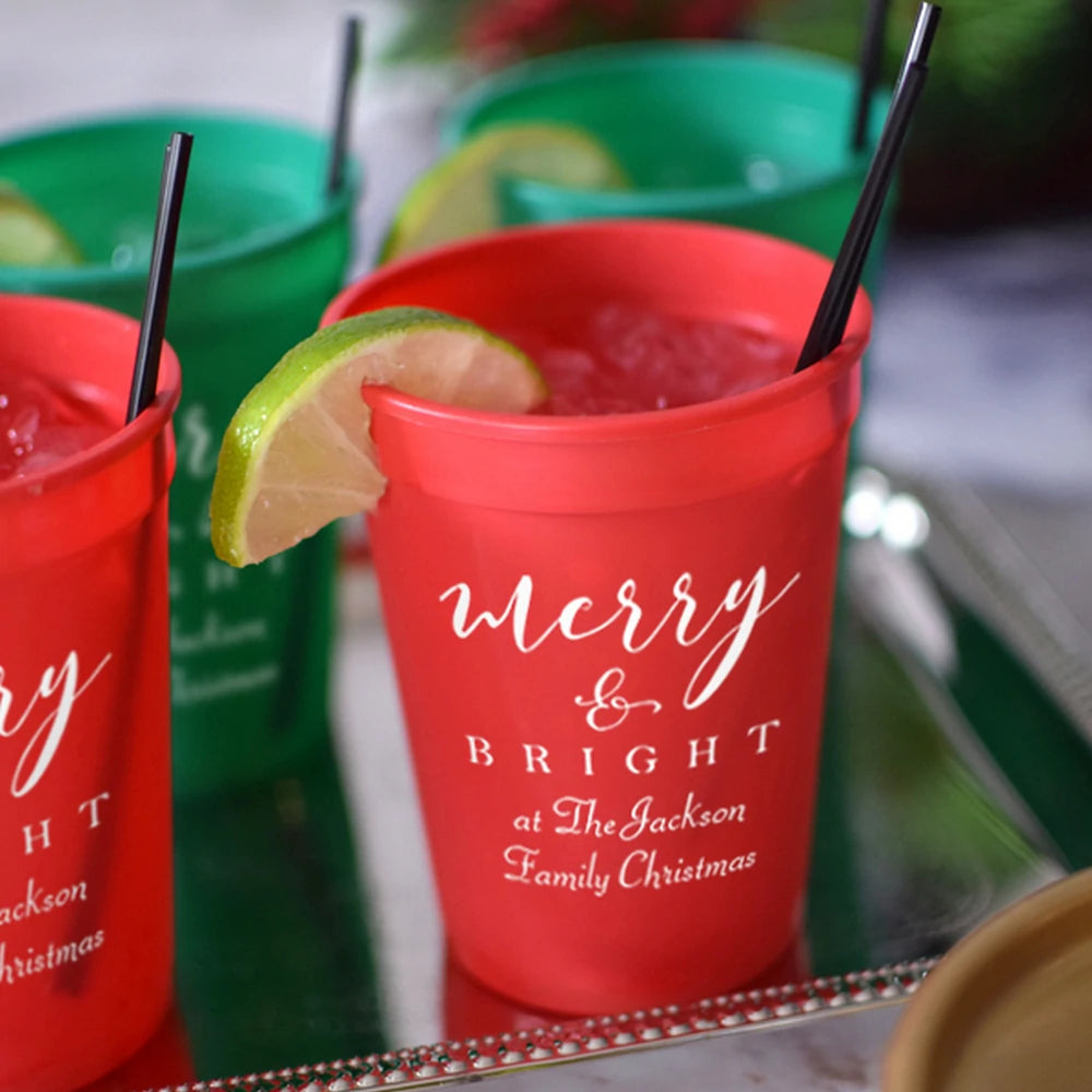 Red 12 oz personalized Christmas party stadium cups with Merry and Bright text and lime garnish by Tippytoad