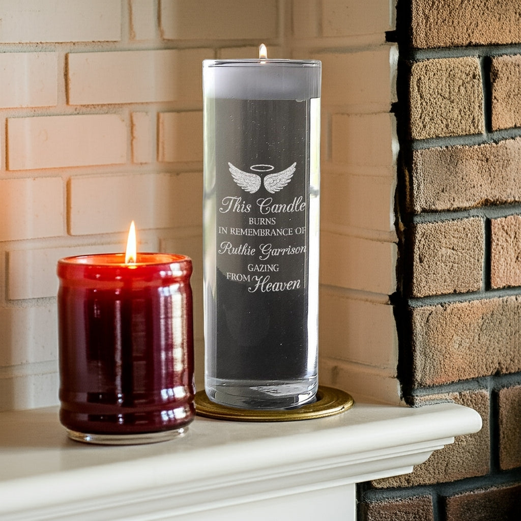 Angel Wings Personalized Memory Candle Vase with engraved remembrance message burning next to a red candle on a mantel