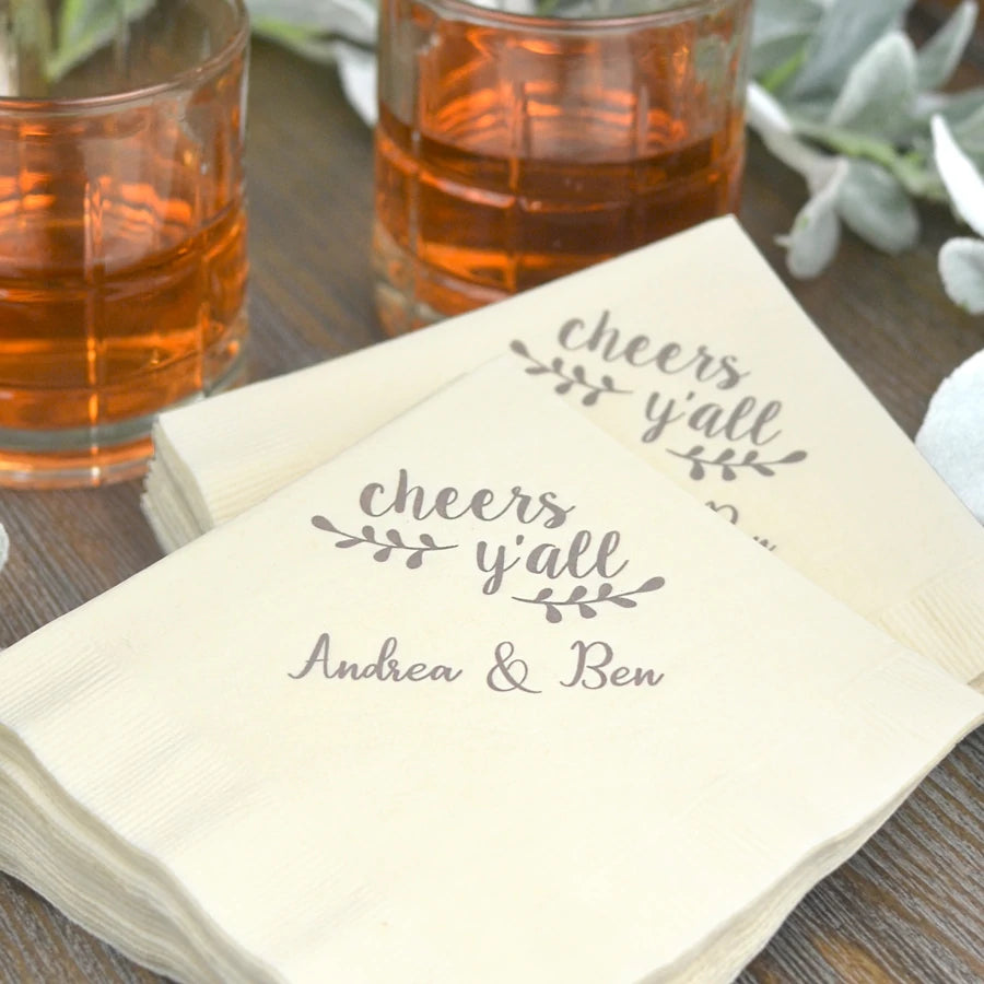 white wedding cocktail napkin personalized with cheers yall design and bride and groom name in silver print