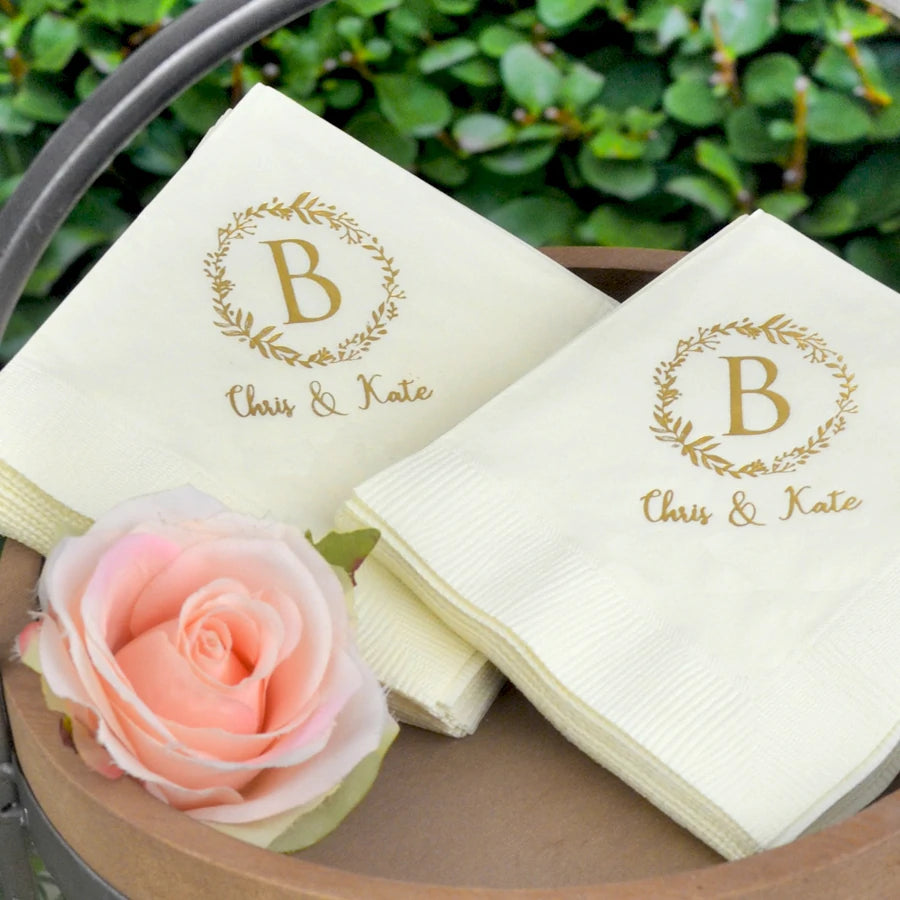 White wedding cocktail napkins personalized with wreath initial monogram 2 lines of custom text in gold print