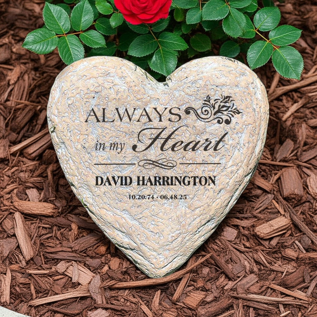 Always In My Heart personalized heart memorial garden stone placed on mulch with green leaves and a red rose