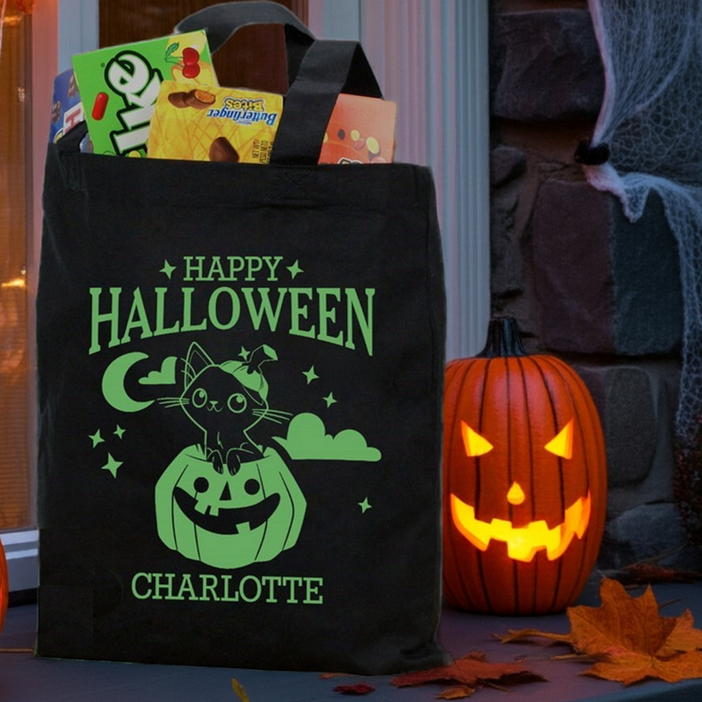Black Halloween tote with green cat in pumpkin personalized trick or treat bag design named Charlotte filled with candy