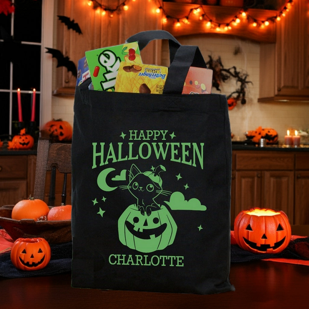 Black Halloween treat bag with green cat in pumpkin personalized trick or treat bag design filled with candy