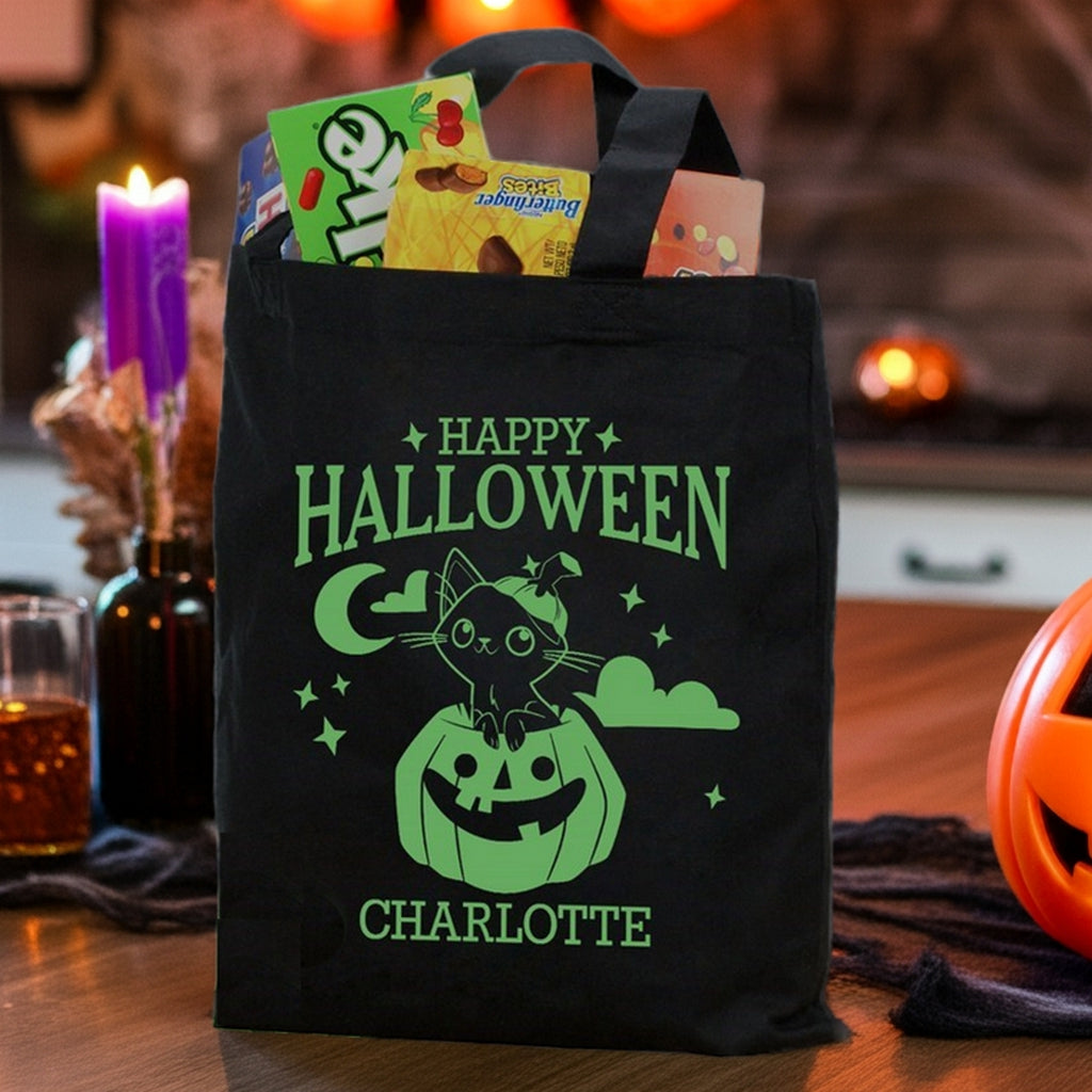 Black reusable Halloween tote showing cat in pumpkin personalized trick or treat bag design with name Charlotte