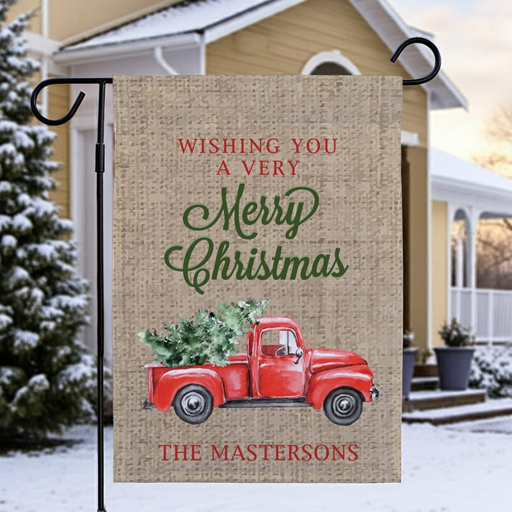 Christmas garden flag featuring a vintage red truck and holiday greetings for a festive touch