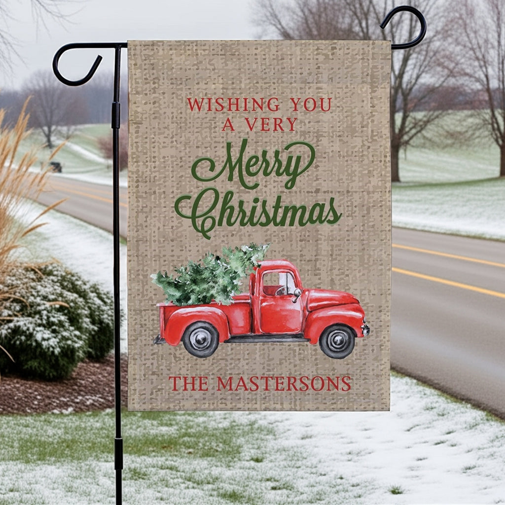 Christmas garden flag featuring a red vintage truck with a Christmas tree and personalized text for The Mastersons