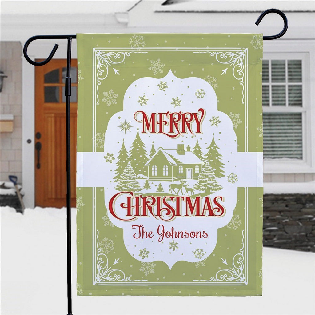 Merry Christmas garden flag featuring a snowy house design personalized for The Johnsons