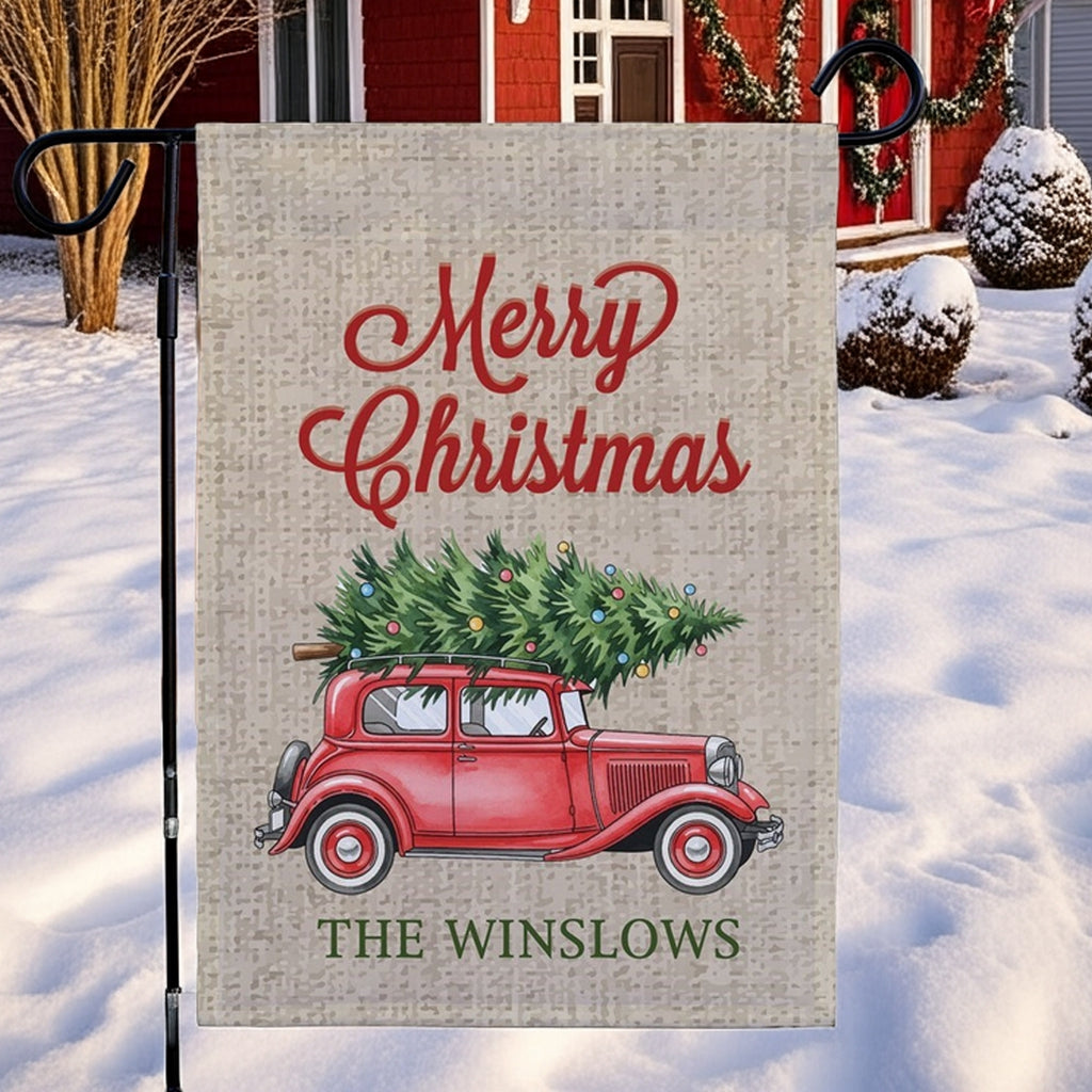 Christmas garden flag featuring a vintage red truck with a Christmas tree and festive lettering