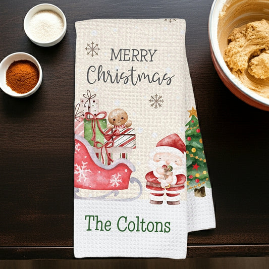 Christmas kitchen towel featuring festive Santa sleigh and snowman with custom name