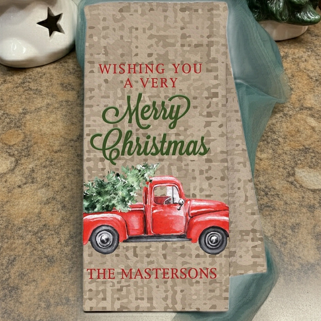 Customized Christmas kitchen towel featuring a red vintage truck with Christmas trees and a festive greeting