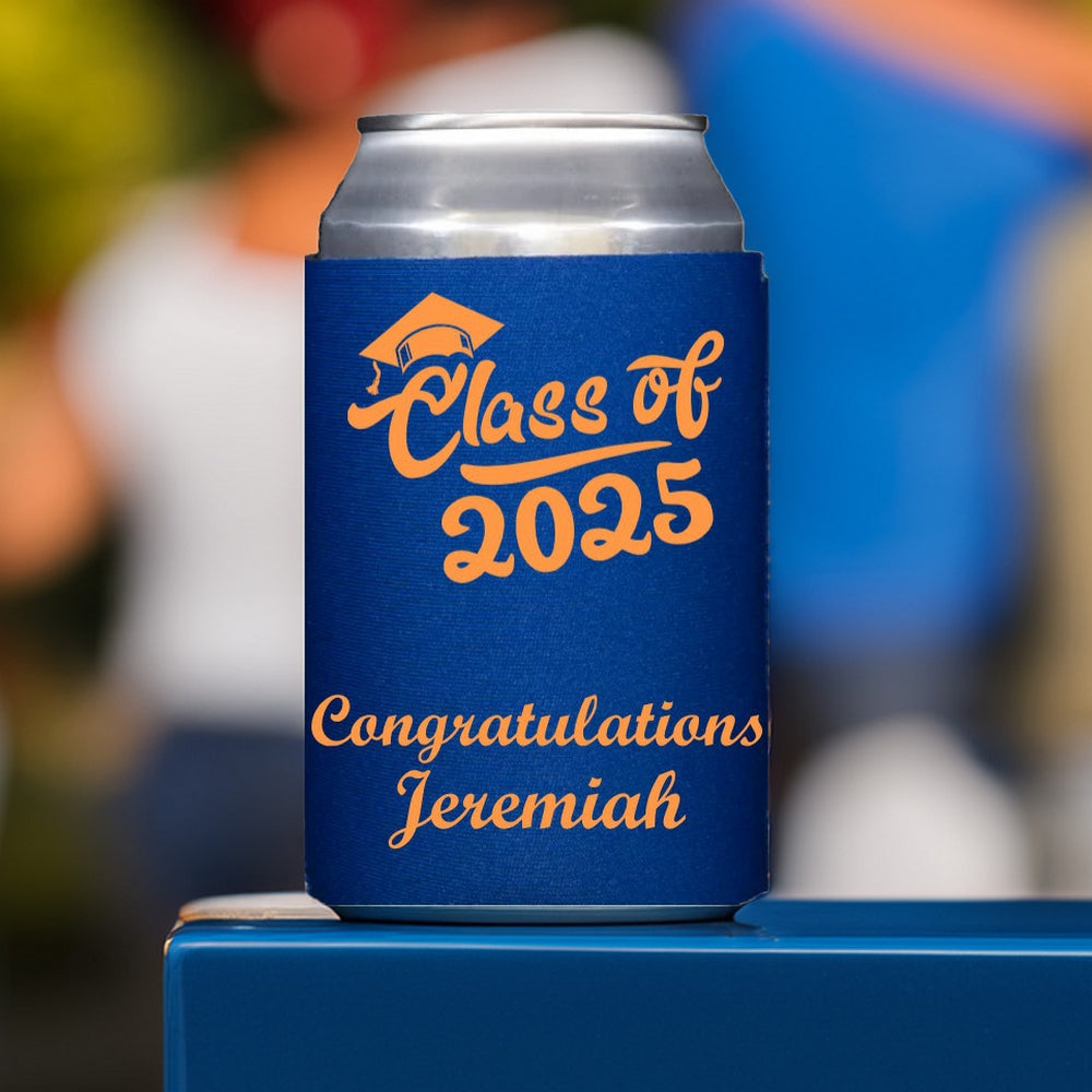 A can covered in a can sleeve personalized for a 2025 grad party in copper print setting on a blue tabletop at a backyard graduation party. The customization on the sleeve features a fun "Class of 2025" fat script graphic with a grad cap over the "C". A "Congratulations" message to the high school graduated in printed below the design in a thick script font.