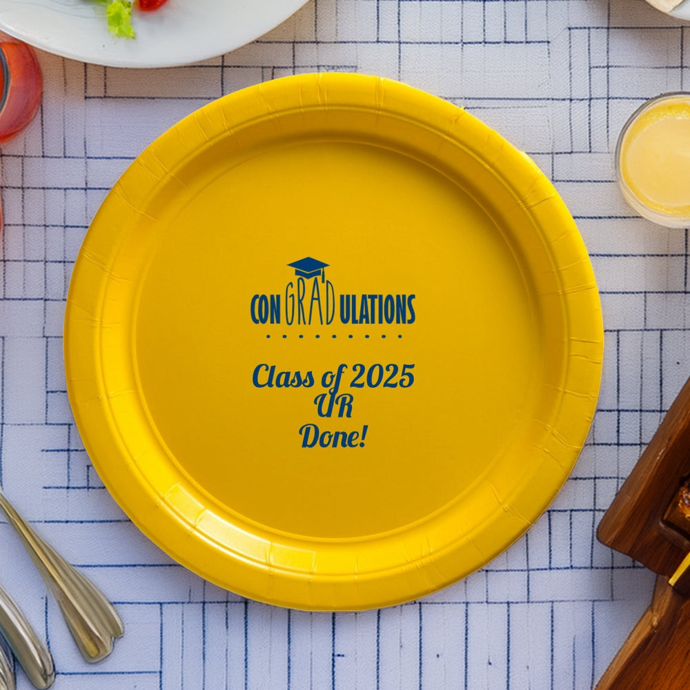 Yellow paper dinner plate personalized for grad party in skipper blue print with "conGRADulations" design and text "Class of 2025, UR Done!"