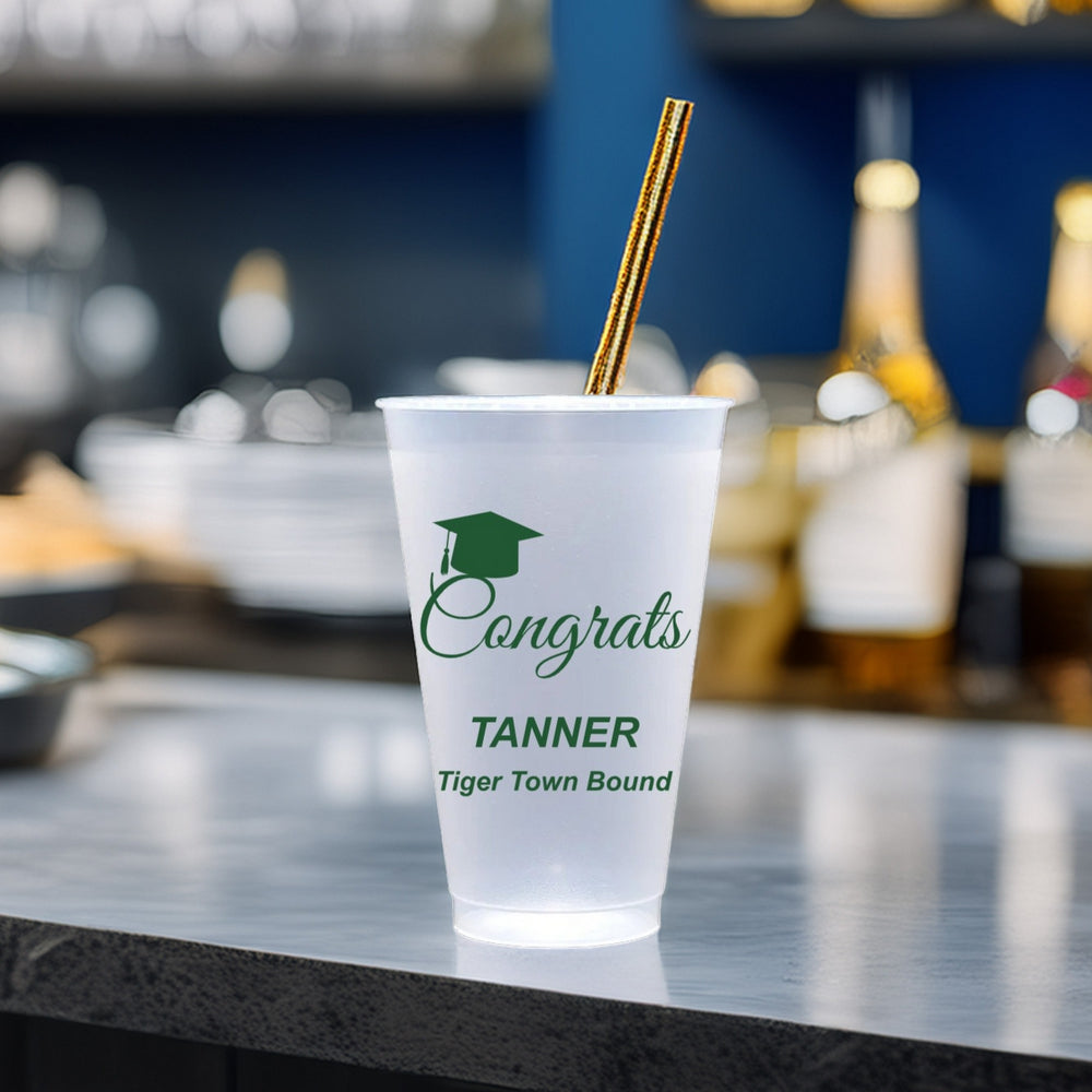 20 Oz frosted plastic graduation cup personalized with "Congrats" design, graduate name and text "Tiger Town Bound" in green print