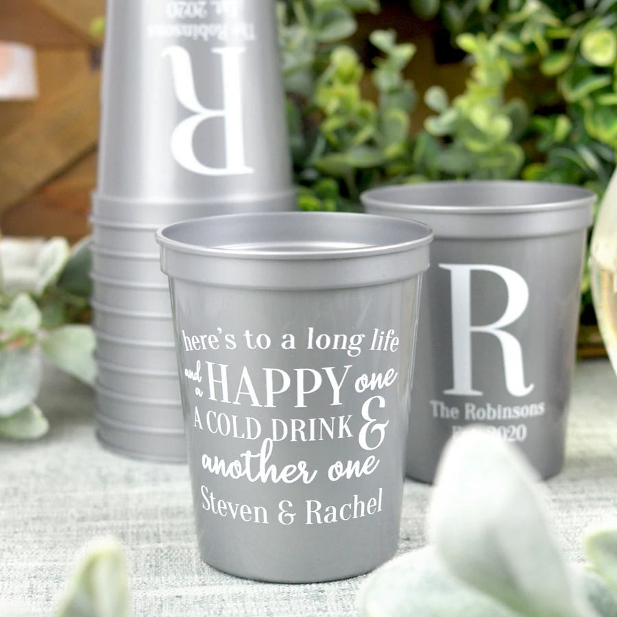 Silver color 16 oz size wedding stadium cups personalized with heres to long life design and bride and groom names in white print