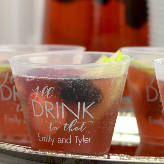 9 Oz Personalized Frosted Wedding Squat Cups with custom names filled with a cocktail and garnish