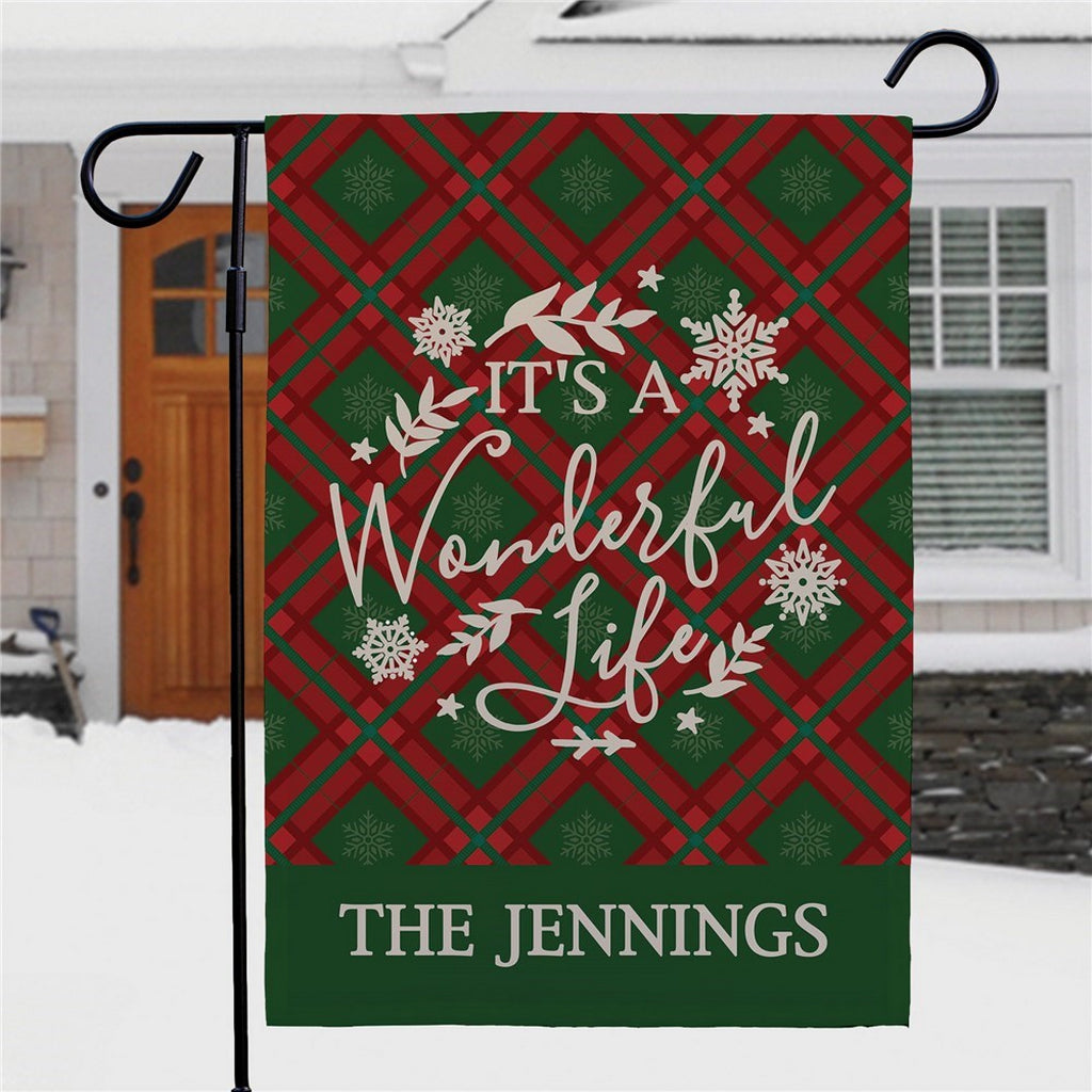 Christmas garden flag featuring a plaid design and festive text, perfect for holiday decor