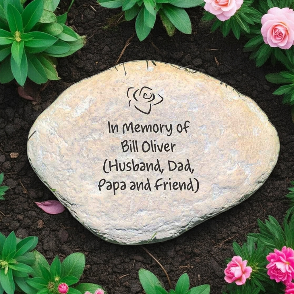 Custom engraved memorial garden stone with in memory of message surrounded by flowers