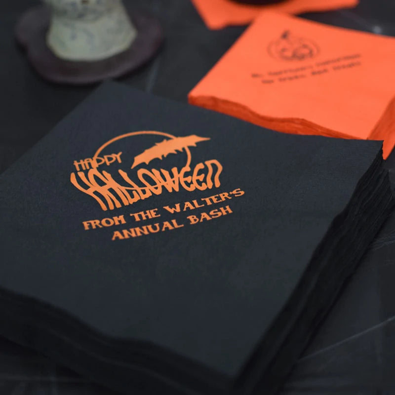 Black and orange Halloween cocktail napkins by Tippytoad with bat graphic and custom party text