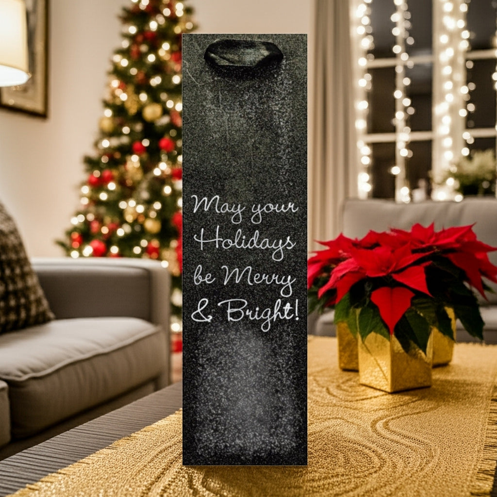 Black glitter wine bottle bag with Merry Bright script on table by tree custom printed glitter christmas wine bottle gift bags