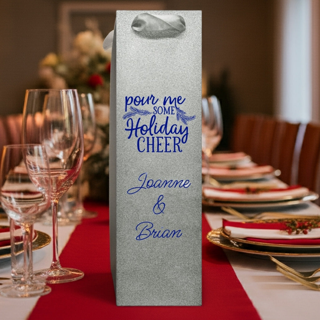 Silver glitter wine bag with blue holiday script Joanne and Brian on table custom printed glitter christmas wine bottle gift bags