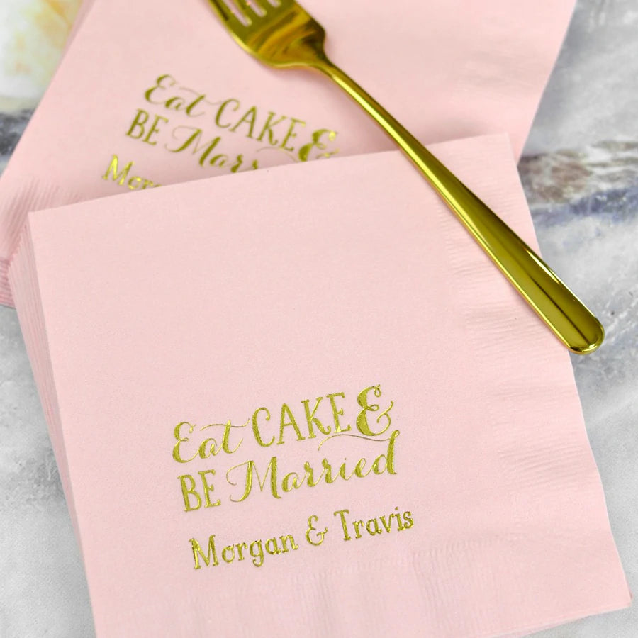 pink wedding luncheon napkins personalized with eat cake and be married design and bride and groom name in gold print for serving wedding cake