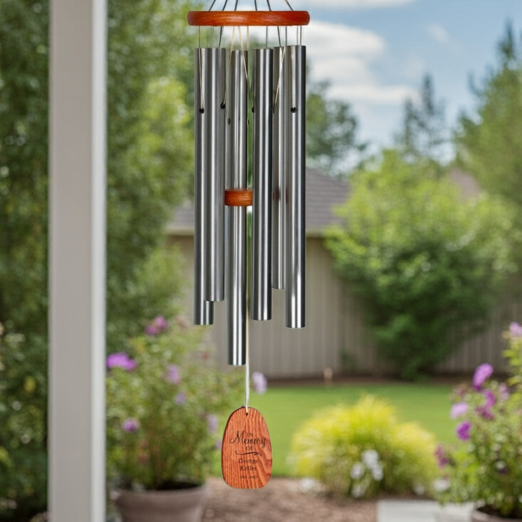 Engraved in loving memory wind chime with wooden top and engraved wooden pendant hanging outdoors