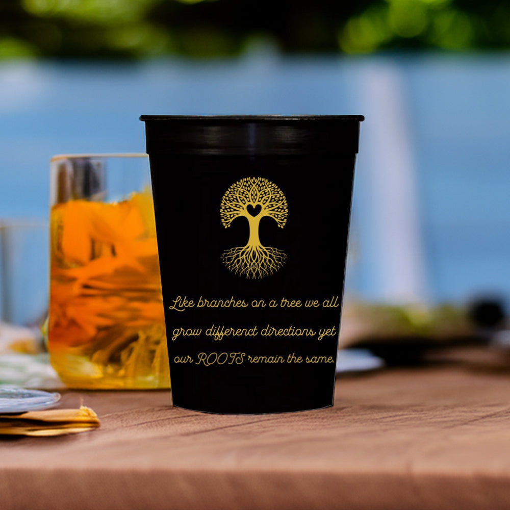 A black stadium cup personalize for family reunion with "Heart Tree" graphic and text "Like branches on a tree we all grow different directions yet our ROOTS remain the same." in gold print