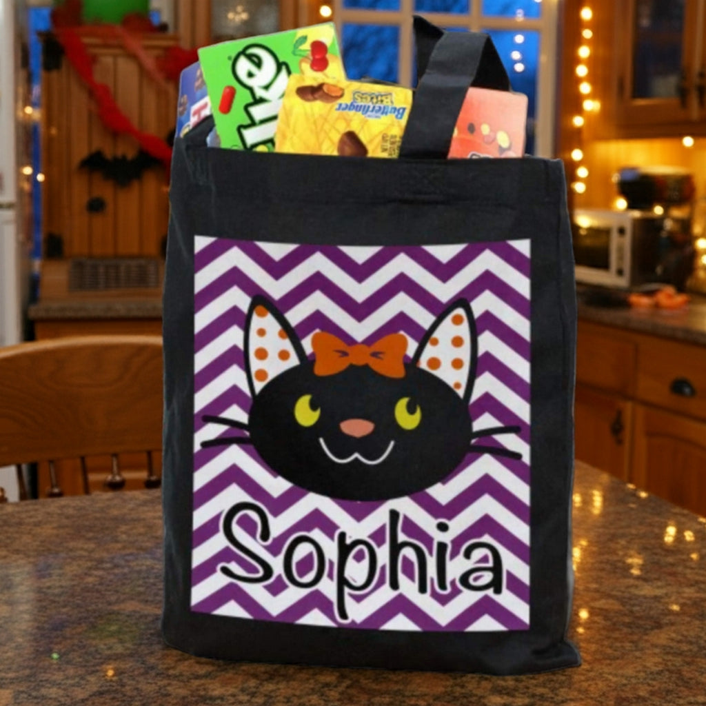 girl black cat personalized trick or treat bag with Sophia name on purple chevron panel filled with candy in kitchen