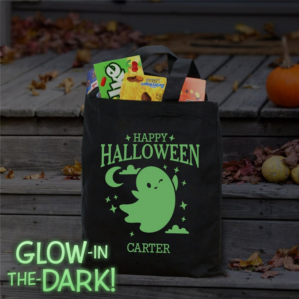 Black tote showing glow in the dark ghost personalized trick or treat bag with Happy Halloween Carter text and candy