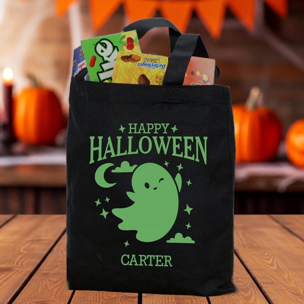 Black canvas Halloween tote with name Carter and candy glow in the dark ghost personalized trick or treat bag
