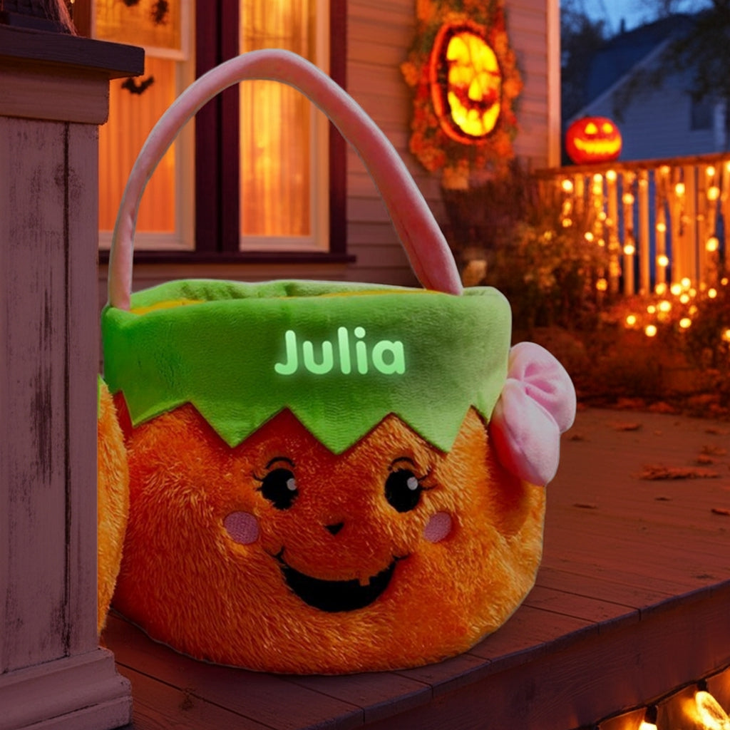 Glow in the dark personalized trick or treat basket shaped like a smiling pumpkin with the name Julia glowing on green top