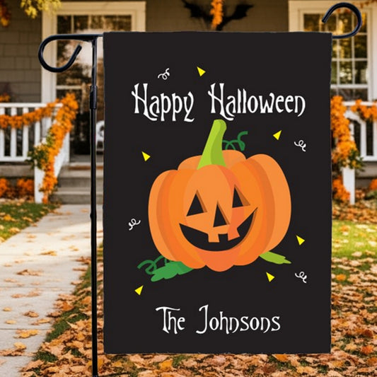 Black Halloween garden flag personalized with smiling jack o lantern Happy Halloween text and The Johnsons