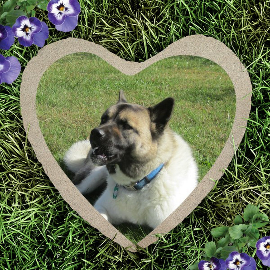 Heart shape custom photo garden stone featuring a dog image on grass with purple flowers