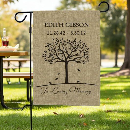 In loving memory tree personalized burlap garden flag with name and dates displayed outdoors