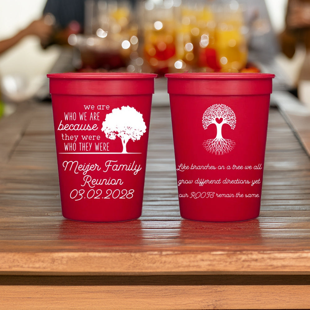 Red family reunion cup favors personalized in white print with "Who We are" and "Heart Tree" graphic designs and custom text in Robust font.