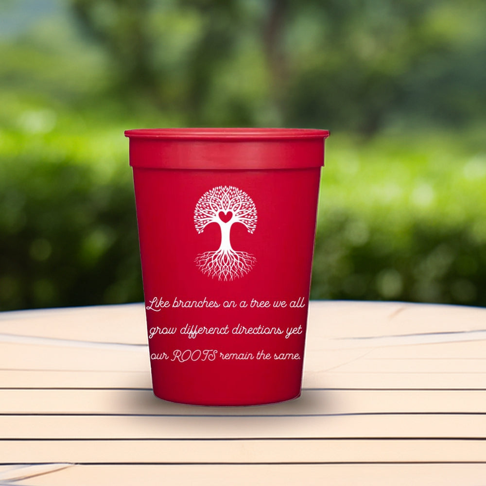 A red plastic cup personalize in white print with "Heart Tree" graphic and text "Like branches on a tree we all grow different directions yet our ROOTS remain the same."