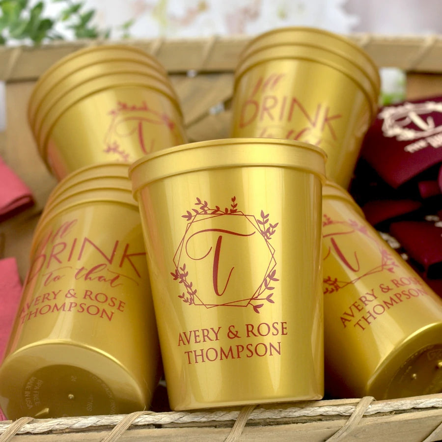 Gold color 16 oz size stadium wedding cups personalized with geodesic wreath initial T and 2 lines of custom text in burgundy print