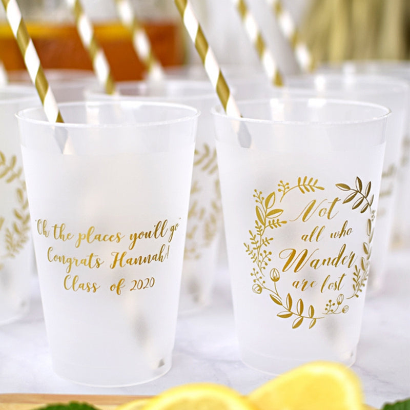 Clear frosted 14 oz. graduation cups personalized with custom text on front side and graduation design "Not All Who Wander" on back side in gold print