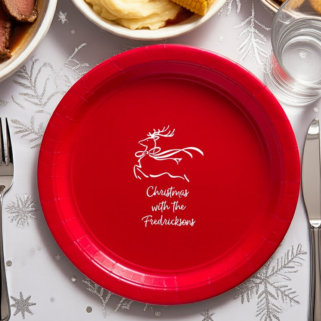 Red paper Christmas dinner plates featuring a festive reindeer design for holiday celebrations
