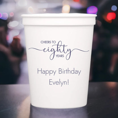 White color adult birthday theme cup personalized with cheers to eighty years design and 2 lines of custom text in dark grey print