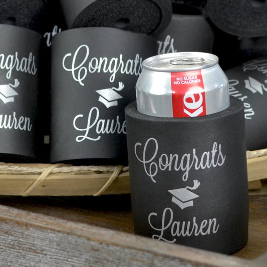 Black color artic foam graduation can cooler favors personalized with congrats grad cap design and graduate name in silver print