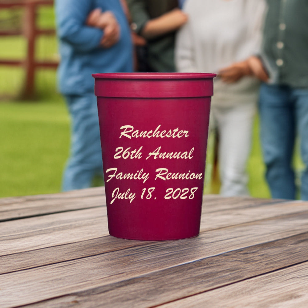 A maroon color cup personalize with four lines of script text in ivory print for family reunion favor idea