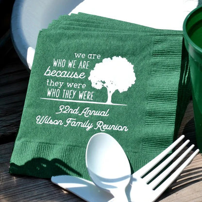 Green color family reunion cocktail napkins personalized with who we are design 2 lines of custom text in white print