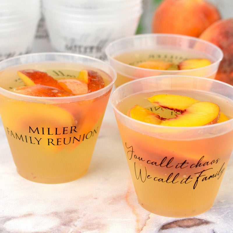 Personalized family reunion squat cups with custom text filled with peach drink and sliced peaches