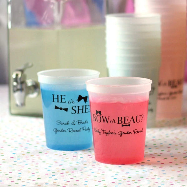 Blue and Pink color changing gender reveal party cup favors personalized with he or she and bow or beau designs and custom text in black print