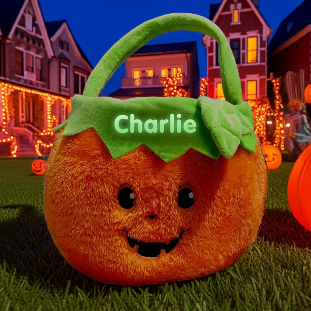 Personalized glow in the dark trick or treat basket shaped like a plush pumpkin with the name Charlie